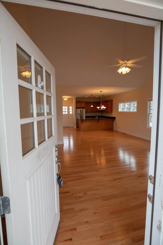 entrance foyer with light wood-style floors, baseboards, and a healthy amount of sunlight