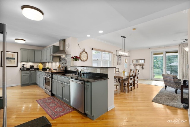 432 S Cherry St, Itasca, IL 60143 - kitchen featuring stainless steel appliances, wall chimney exhaust hood, dark countertops, gray cabinetry, and light wood finished floors