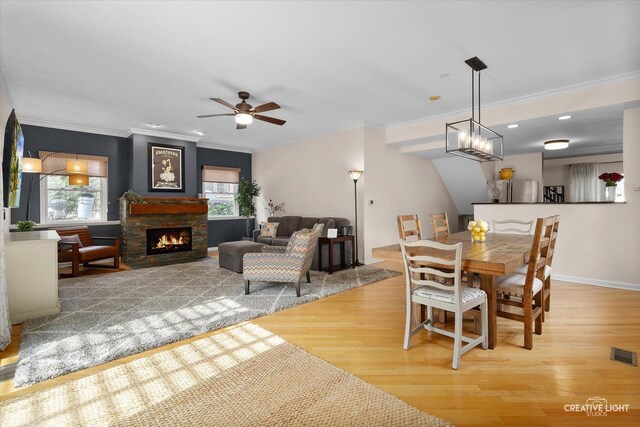 432 S Cherry St, Itasca, IL 60143 - dining room featuring light wood-style floors, crown molding, a fireplace, and a ceiling fan