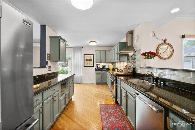 432 S Cherry St, Itasca, IL 60143 - kitchen featuring stainless steel appliances, wall chimney exhaust hood, tasteful backsplash, and light wood-style floors
