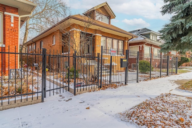 view of front of home featuring a fenced front yard and brick siding