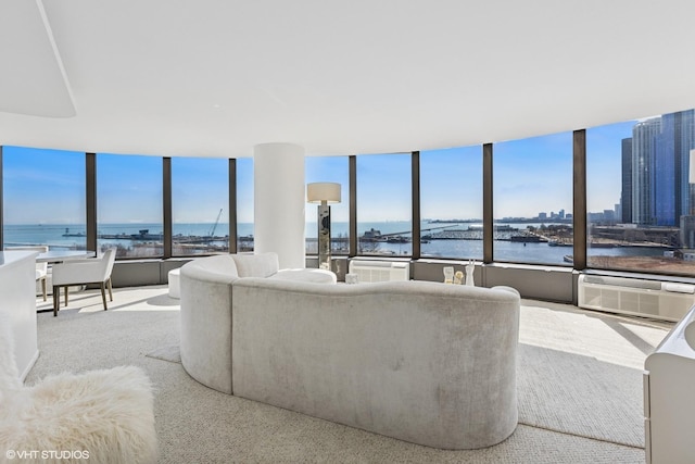 living area with an AC wall unit and a water view