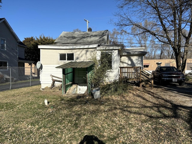 608 E Washington St, Joliet, IL 60433 - rear view of house featuring a lawn and fence
