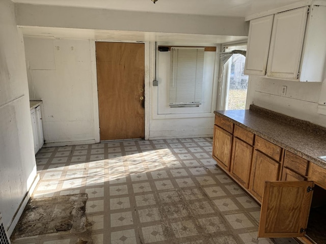 608 E Washington St, Joliet, IL 60433 - kitchen featuring dark countertops, white cabinets, and light floors