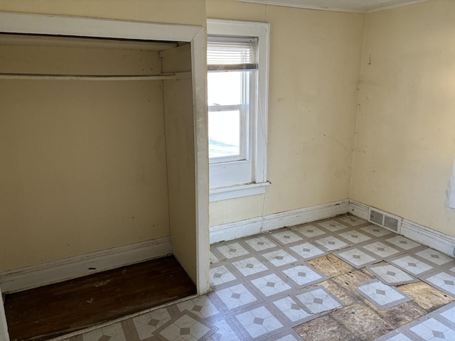 608 E Washington St, Joliet, IL 60433 - unfurnished bedroom with light floors, visible vents, and baseboards