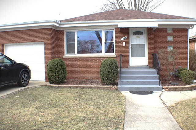 ranch-style house with brick siding, a shingled roof, entry steps, a front yard, and an attached garage