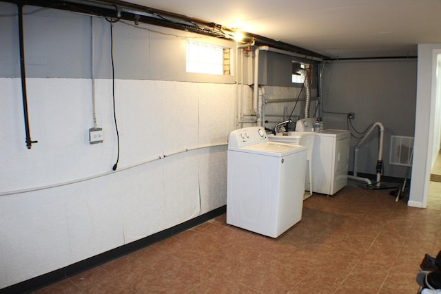 washroom with laundry area, visible vents, and washer and clothes dryer