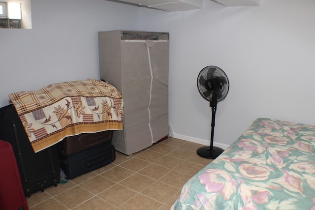 bedroom with light tile patterned floors and baseboards