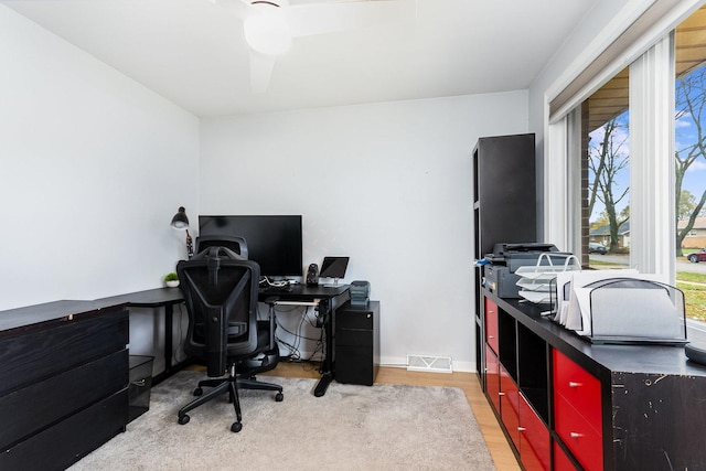 office featuring wood finished floors, visible vents, and baseboards