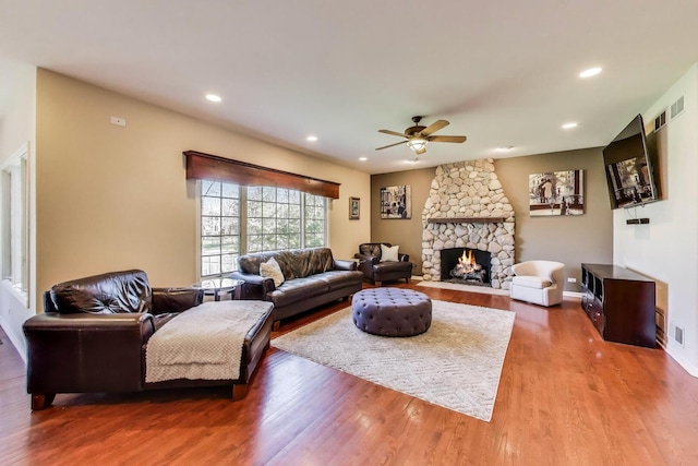 1056 W Willow St, Palatine, IL 60067 - living room featuring wood finished floors, ceiling fan, a stone fireplace, and visible vents