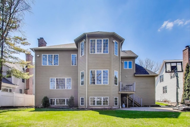 1056 W Willow St, Palatine, IL 60067 - rear view of house featuring a yard, a chimney, fence, and stairs
