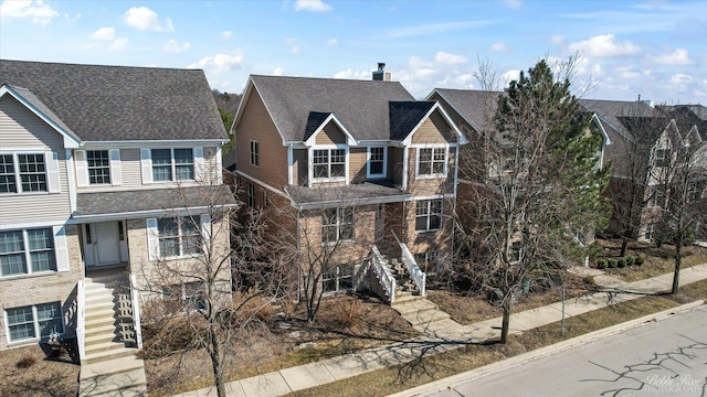 traditional-style house with a chimney and stairs