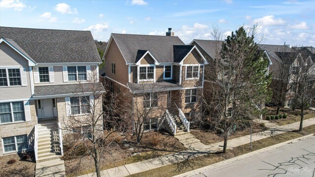 6005 River Bend Dr, Lisle, IL 60532 - traditional-style house featuring stairway and a chimney
