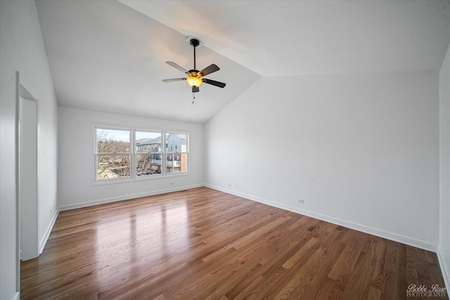 6005 River Bend Dr, Lisle, IL 60532 - spare room featuring a ceiling fan, lofted ceiling, wood finished floors, and baseboards