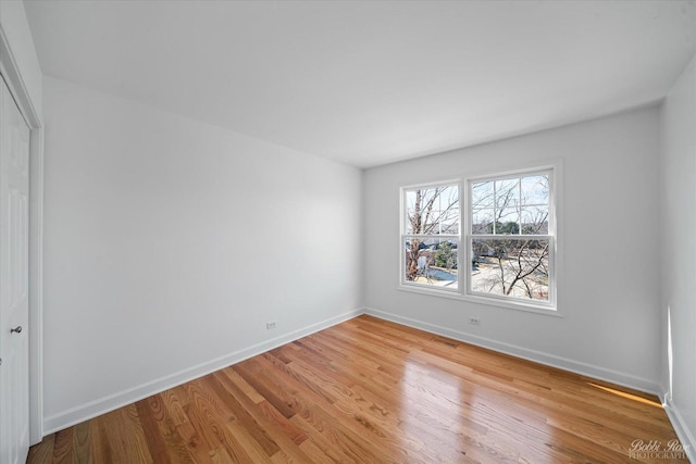 interior space featuring a closet, visible vents, baseboards, and light wood-style floors