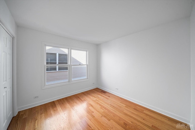 interior space featuring baseboards and light wood finished floors