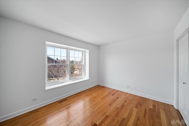 6005 River Bend Dr, Lisle, IL 60532 - spare room with wood finished floors, visible vents, and baseboards