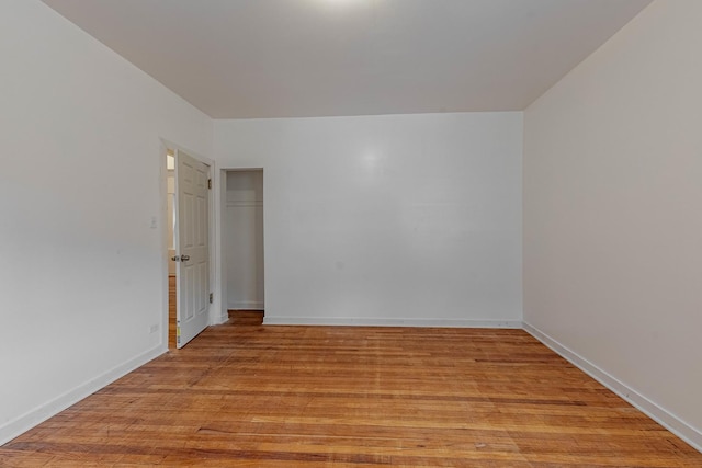 spare room with light wood-style floors and baseboards