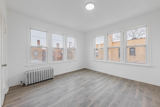 unfurnished sunroom with a healthy amount of sunlight and radiator