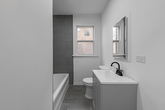 bathroom with vanity, baseboards, walk in shower, toilet, and a bathtub