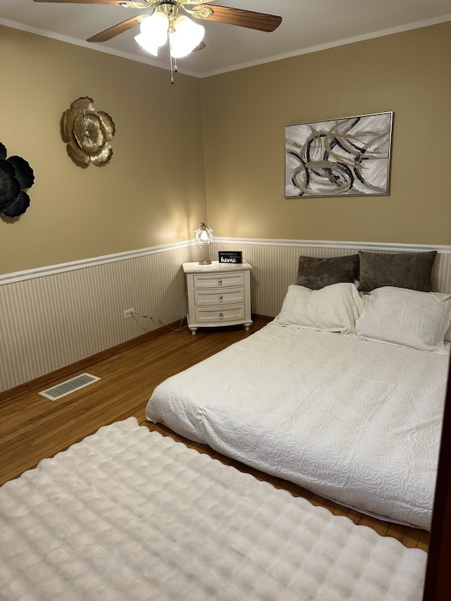 6724 W 114th St, Worth, IL 60482 - bedroom featuring wood finished floors, ornamental molding, a wainscoted wall, and a ceiling fan