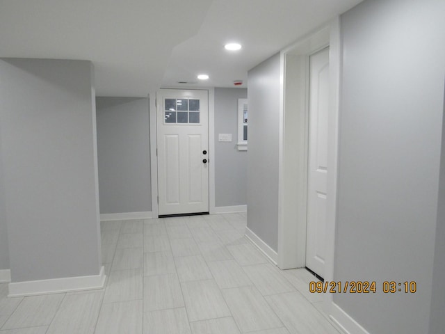 foyer entrance with recessed lighting and baseboards