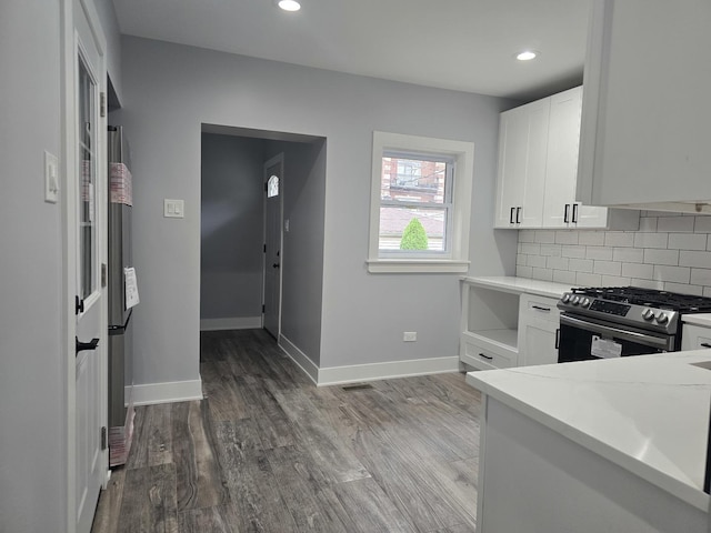 kitchen featuring light countertops, white cabinets, appliances with stainless steel finishes, and wood finished floors