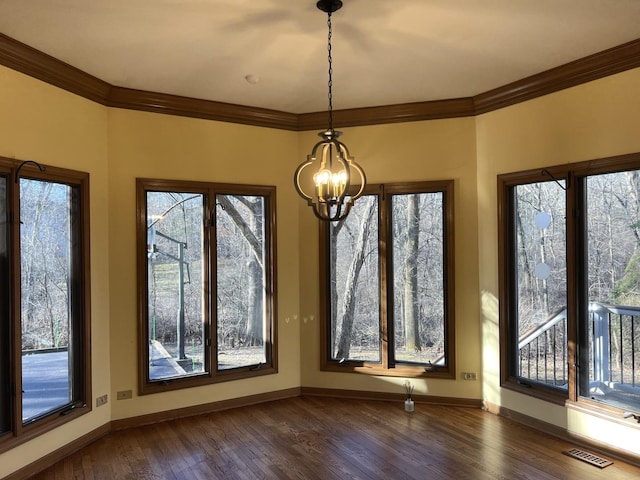 unfurnished dining area featuring a chandelier, visible vents, crown molding, and dark wood-style floors