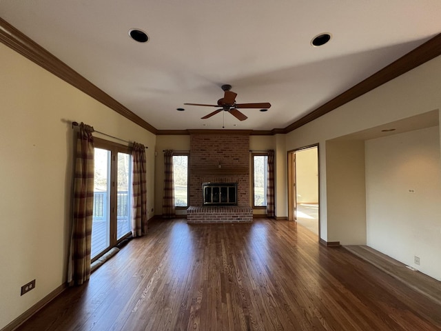 unfurnished living room featuring a fireplace, dark wood-type flooring, a ceiling fan, and ornamental molding