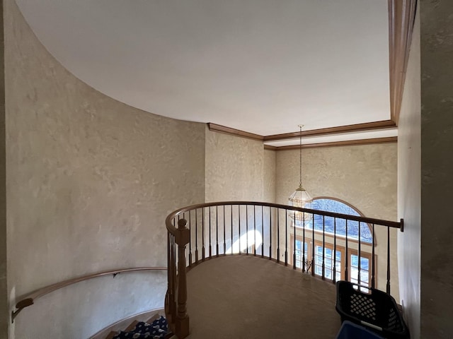 stairs featuring crown molding and a textured wall