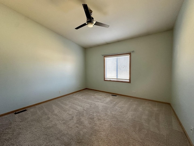 unfurnished room with visible vents, baseboards, carpet, lofted ceiling, and a ceiling fan