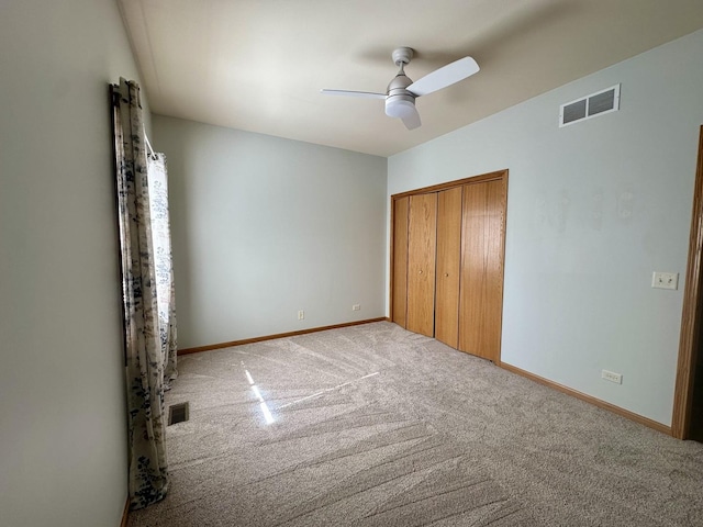 unfurnished bedroom with a closet, visible vents, baseboards, and carpet