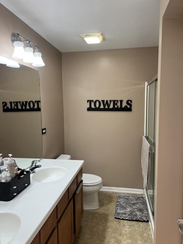 full bath with a stall shower, double vanity, and a sink