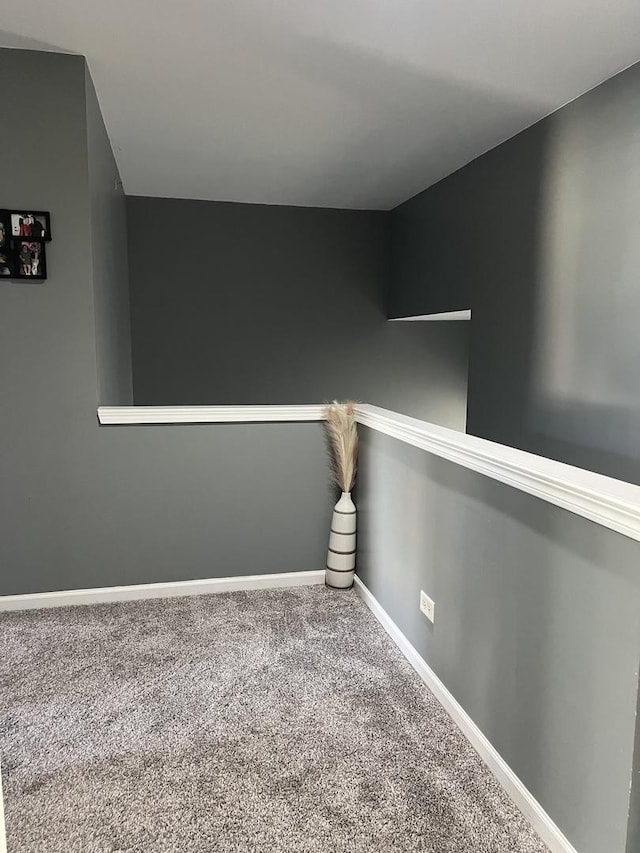 carpeted spare room with baseboards