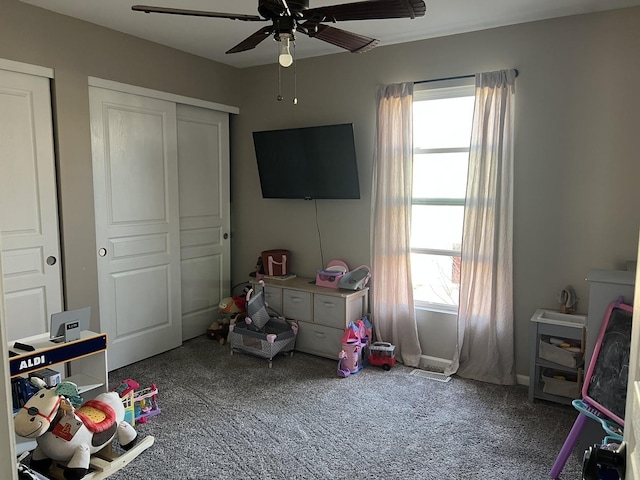 recreation room with ceiling fan, a healthy amount of sunlight, and carpet