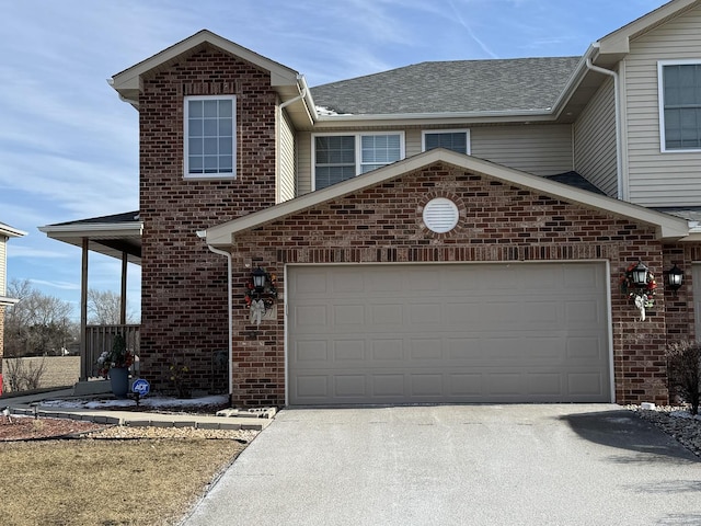 997 Regent Dr, Matteson, IL 60443 - view of front facade with driveway, brick siding, an attached garage, and a shingled roof