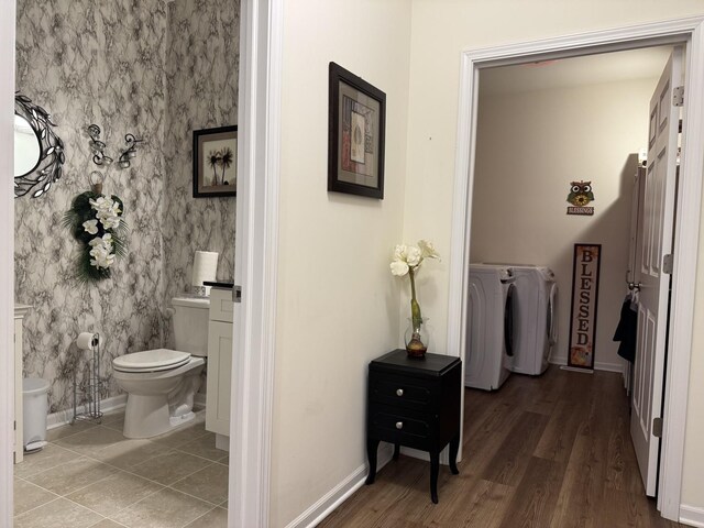 997 Regent Dr, Matteson, IL 60443 - half bath with washing machine and clothes dryer, baseboards, toilet, and wood finished floors