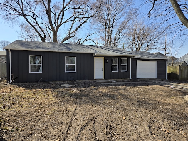 single story home with a garage, fence, and board and batten siding