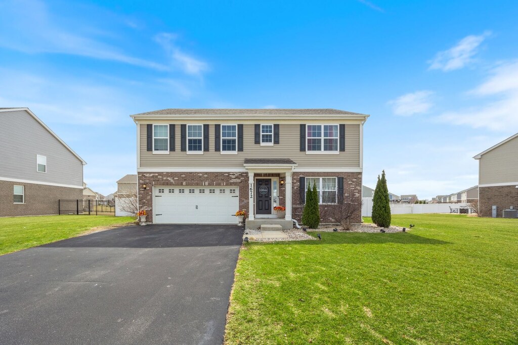 1672 Glenbrooke Ln, New Lenox, IL 60451 - view of front of home with driveway, fence, brick siding, a front lawn, and a garage
