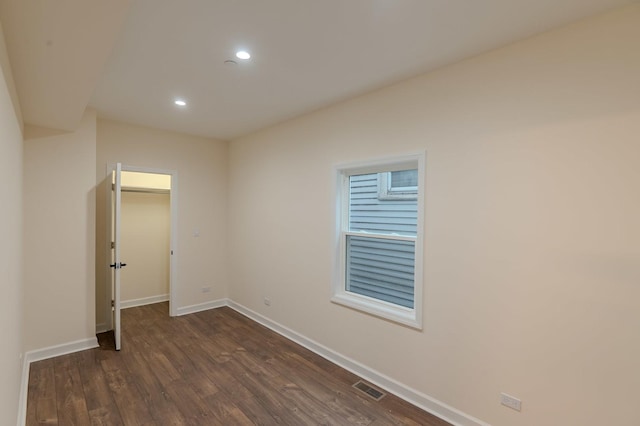 1131 S Ridgeland Ave, Oak Park, IL 60304 - unfurnished bedroom with visible vents, dark wood-style flooring, recessed lighting, baseboards, and a spacious closet