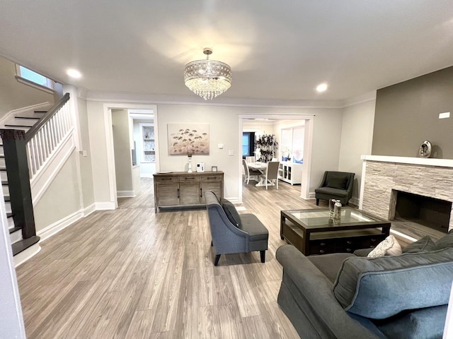 7223 S Paxton Ave, Chicago, IL 60649 - living room with stairs, light wood finished floors, a notable chandelier, and baseboards