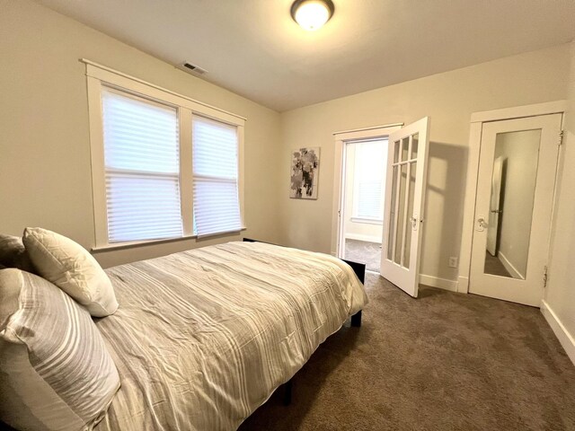 7223 S Paxton Ave, Chicago, IL 60649 - bedroom with dark colored carpet, visible vents, and baseboards