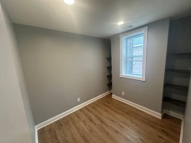 5208 S Paulina St, Chicago, IL 60609 - unfurnished bedroom with visible vents, baseboards, and wood finished floors