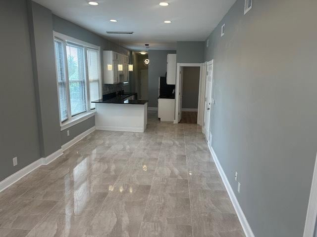 5208 S Paulina St, Chicago, IL 60609 - kitchen with visible vents, baseboards, dark countertops, and white cabinets
