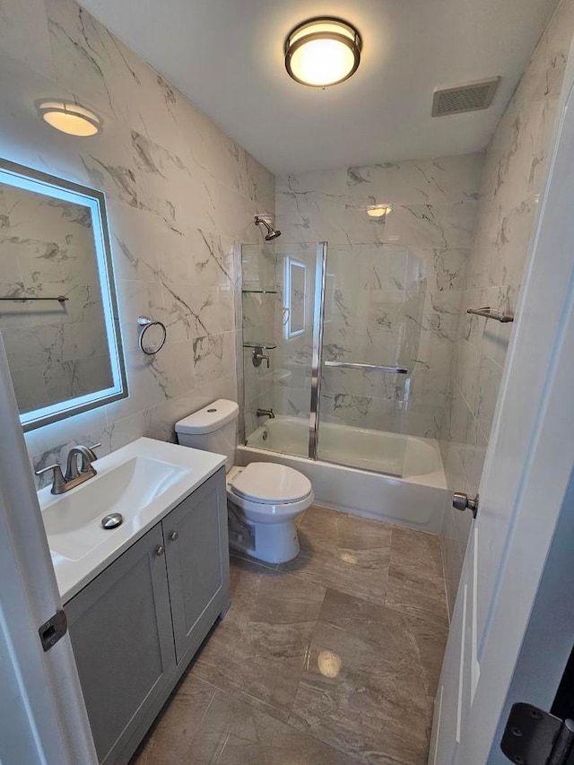 5208 S Paulina St, Chicago, IL 60609 - bathroom featuring vanity, visible vents, tile walls, toilet, and shower / bathtub combination