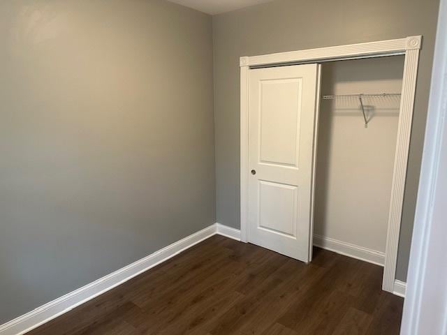 5208 S Paulina St, Chicago, IL 60609 - unfurnished bedroom with a closet, dark wood-type flooring, and baseboards