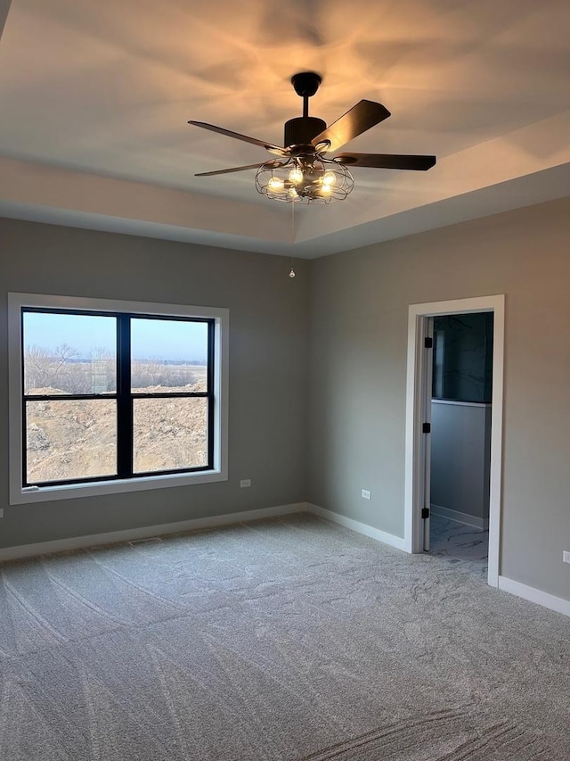 empty room featuring baseboards, ceiling fan, and carpet floors