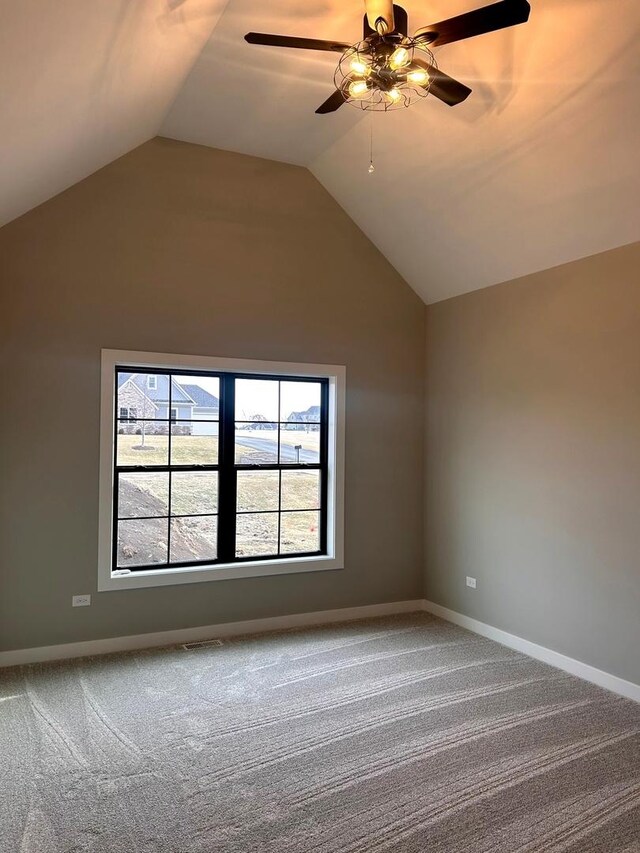 unfurnished room with lofted ceiling, a ceiling fan, baseboards, and carpet floors