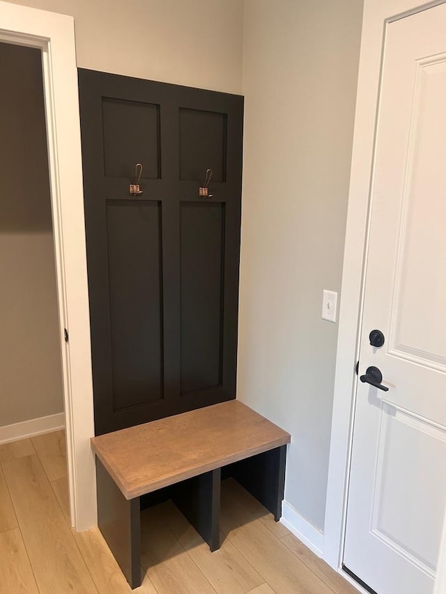mudroom with baseboards and light wood-style floors