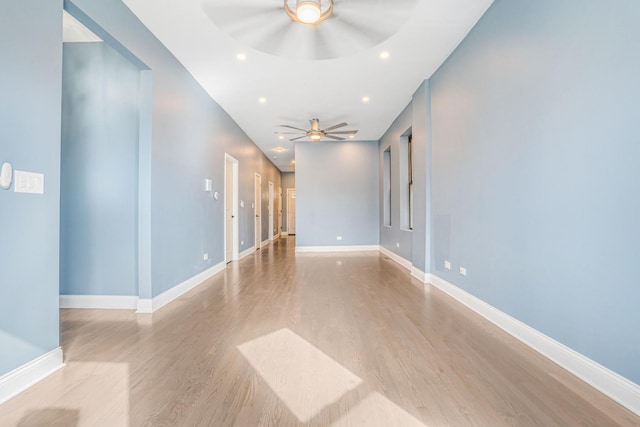unfurnished room featuring recessed lighting, wood finished floors, baseboards, and ceiling fan